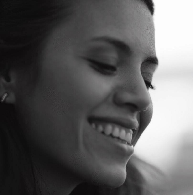Black-and-white portrait of Kelly smiling